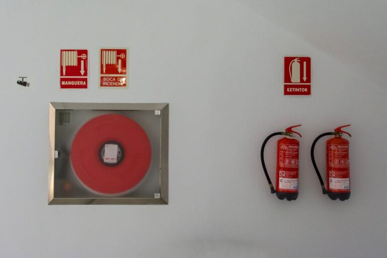 pexels photo 16517206 Fire safety setup with extinguishers and hose reel on a white wall for emergency preparedness.
